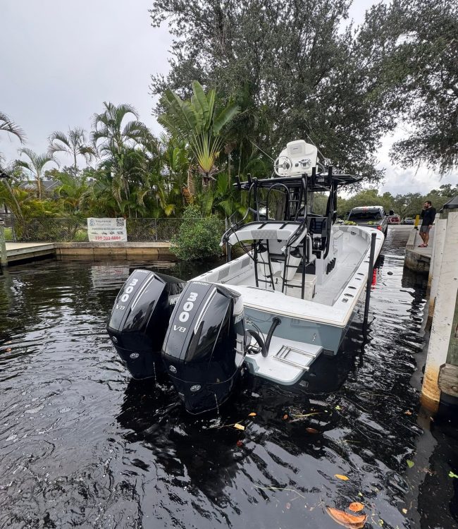 Deluxe Marine launching a center console with twin Mercury 300 V8 outboards at a SWFL boat ramp
