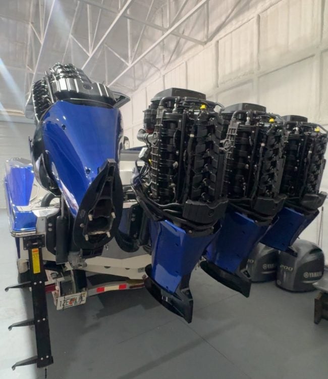 Blue center console with quad Mercury outboards, cowlings off and powerheads exposed for repower in Southwest Florida